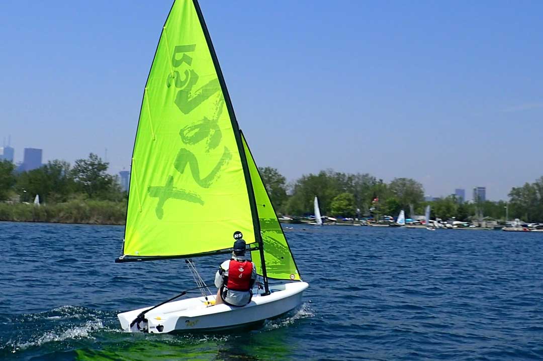 On person sailing with green sails