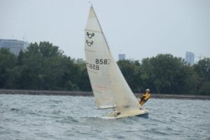 A sailor hiking back in a 505 sailboat