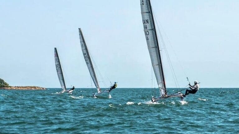 Three racing catamarans in a line