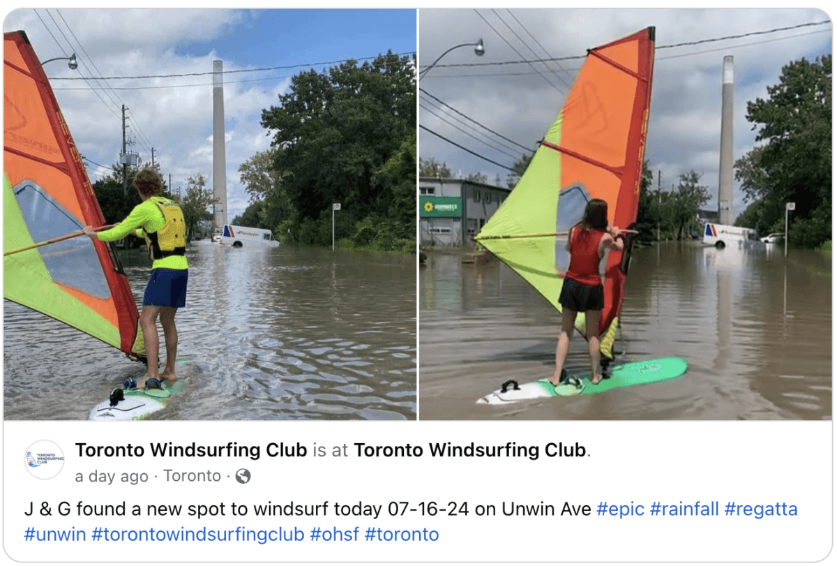 Two windsurfers on flooded street