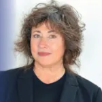 Headshot of a woman with curly hair