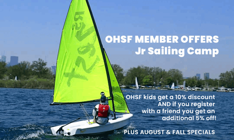 Green sail on sailboat with teen