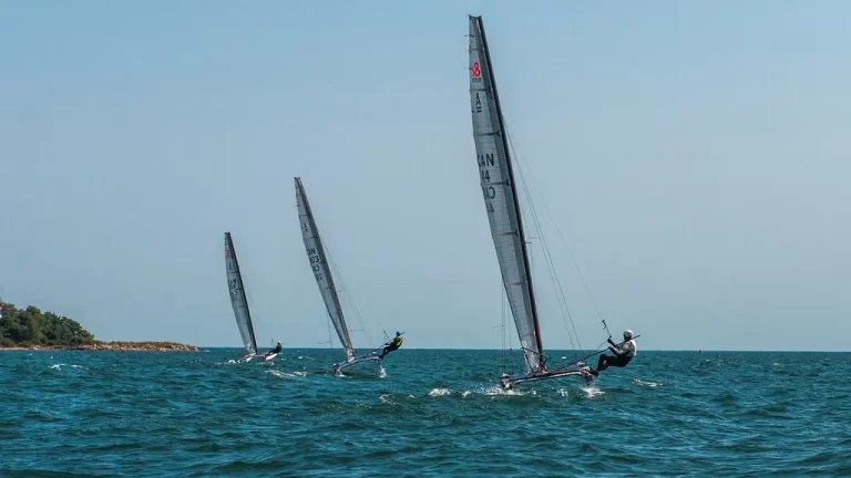 Three catamarans hiking in the wind