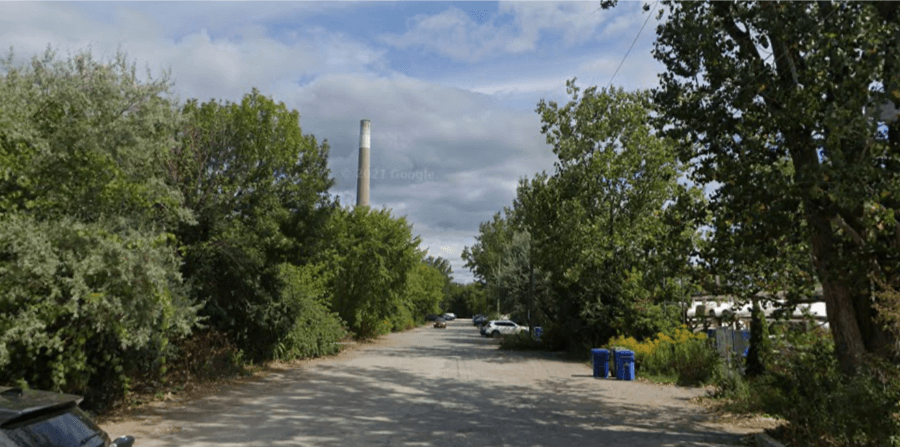 Parking area with a smokestack in distance